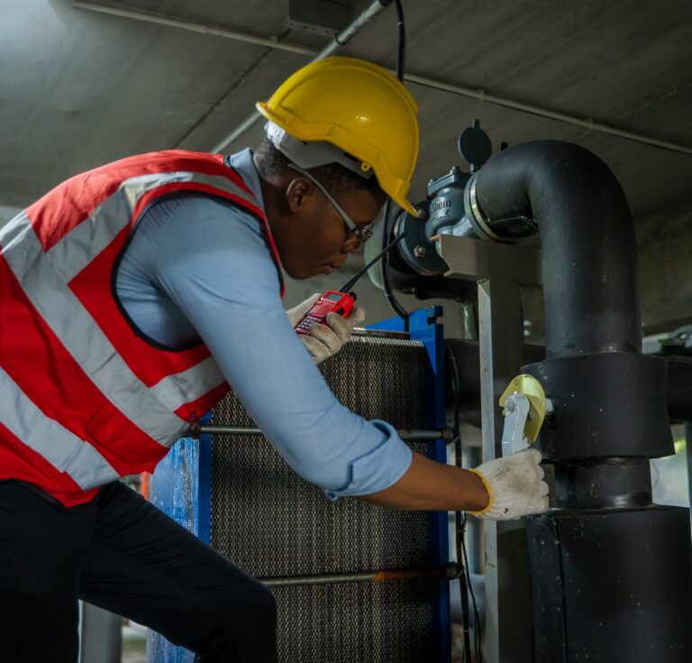 Engineer checking the water pipe system in the factory,Inspecting Water Valve For Leaks In Basement.